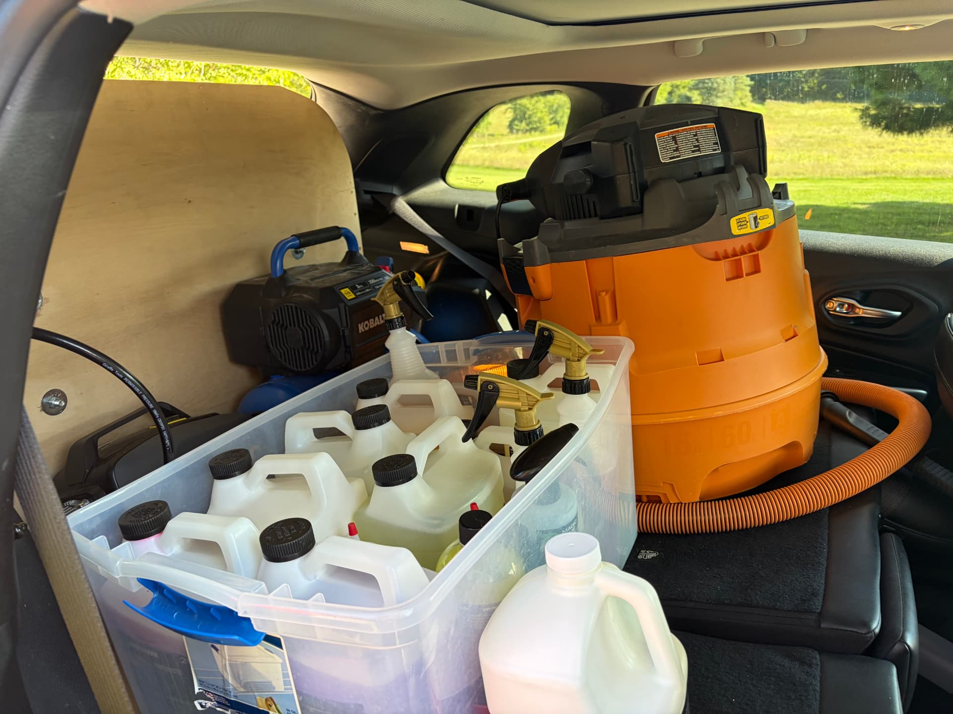 Air compressor, wet/dry vacuum, and organized professional-grade chemical kit